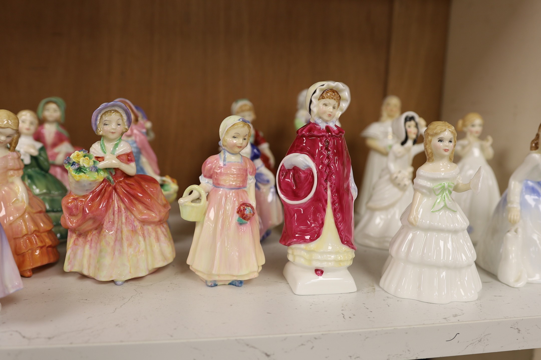 A collection of twenty five Royal Doulton figurines; Mandy, Penny, Ivy, the Rag Doll, Rose, Cissie, Tinkle Bell, Georgina, Julie, Andrea, Francine, Goody Two Shoes, Catherine, Helen, Anna, Dinky Do, Wendy, Belle, Marie,